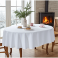 Biały obrus owalny Lena Premium na stole przy kominku z kawą i domowym ciastem, tkanina plamoodporna